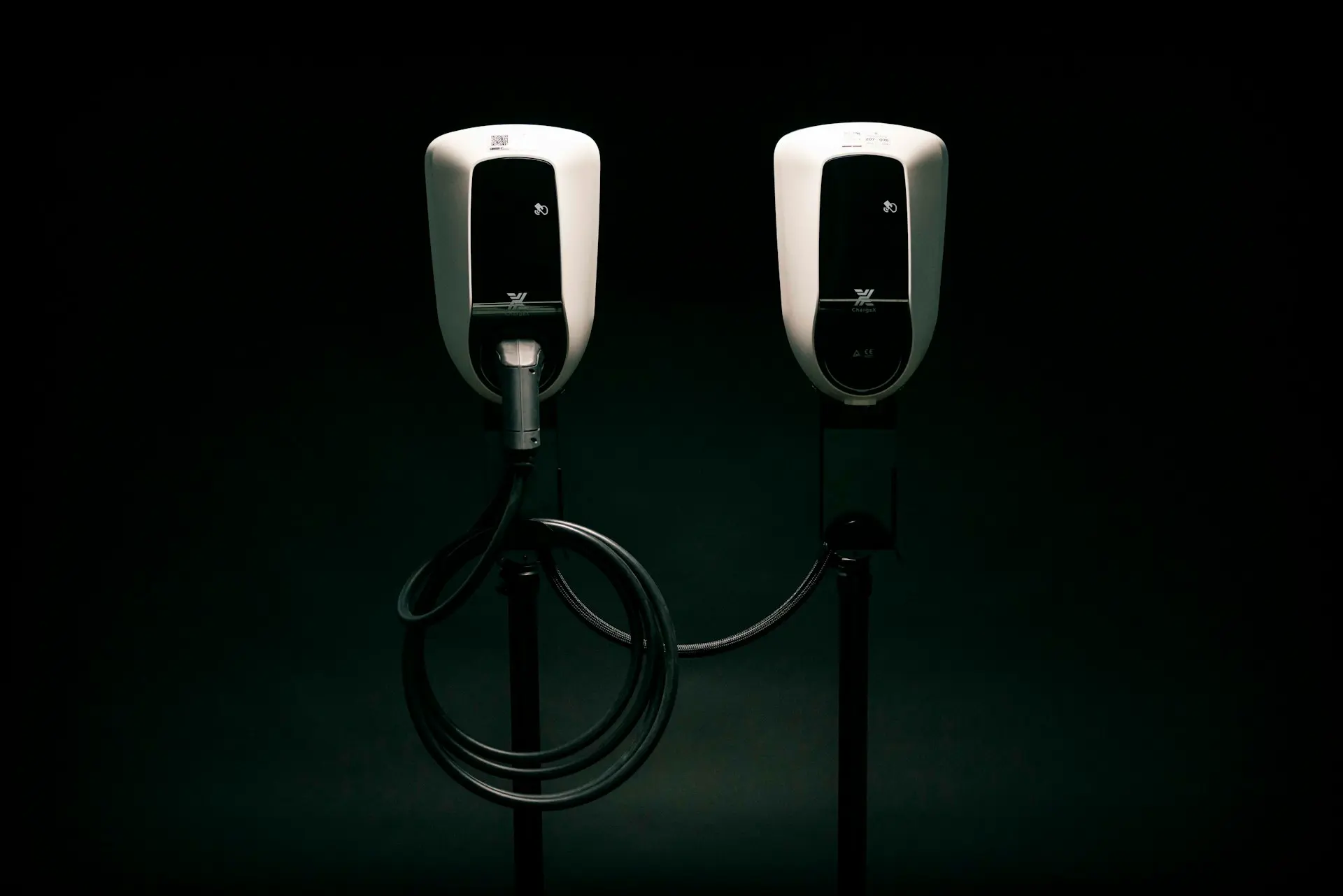 a couple of black and white phones on a black background